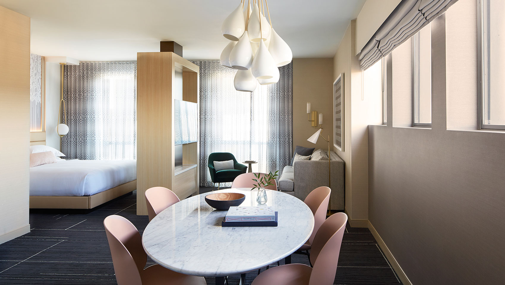 Hollywood Suite dining area with view of bedroom and sitting area at Kimpton Hotel Wilshire