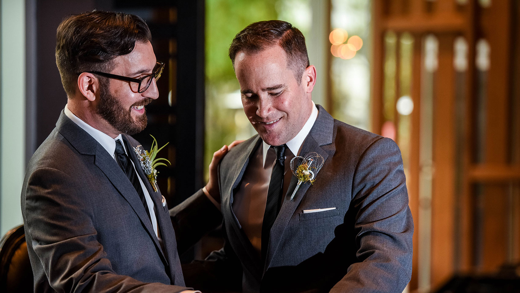 Grooms smiling at each other